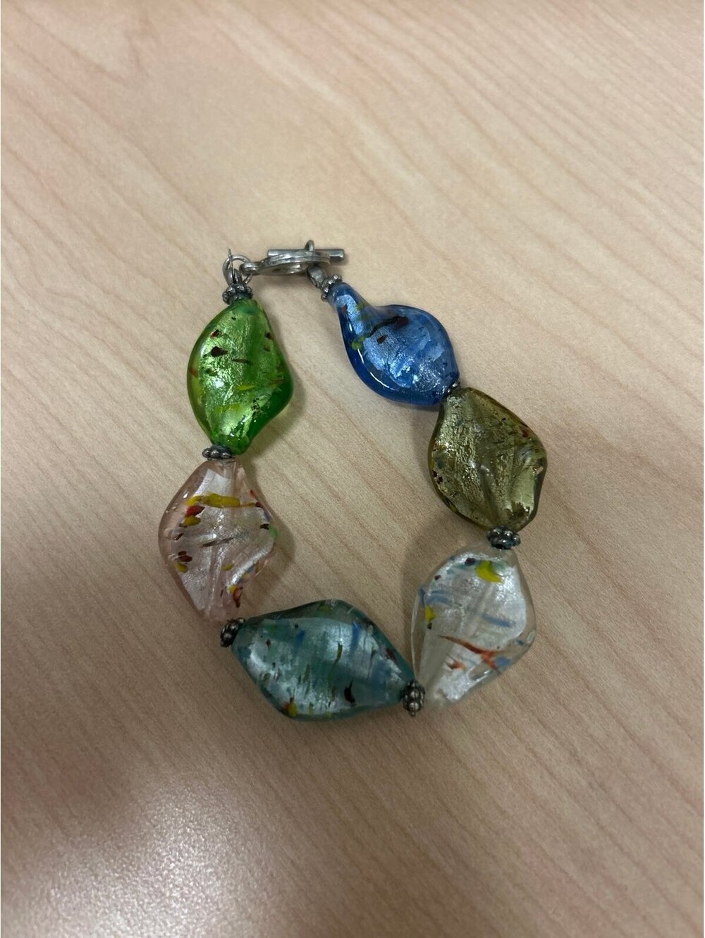 Colorful art glass bracelet featuring chunky, multicolored foiled glass links